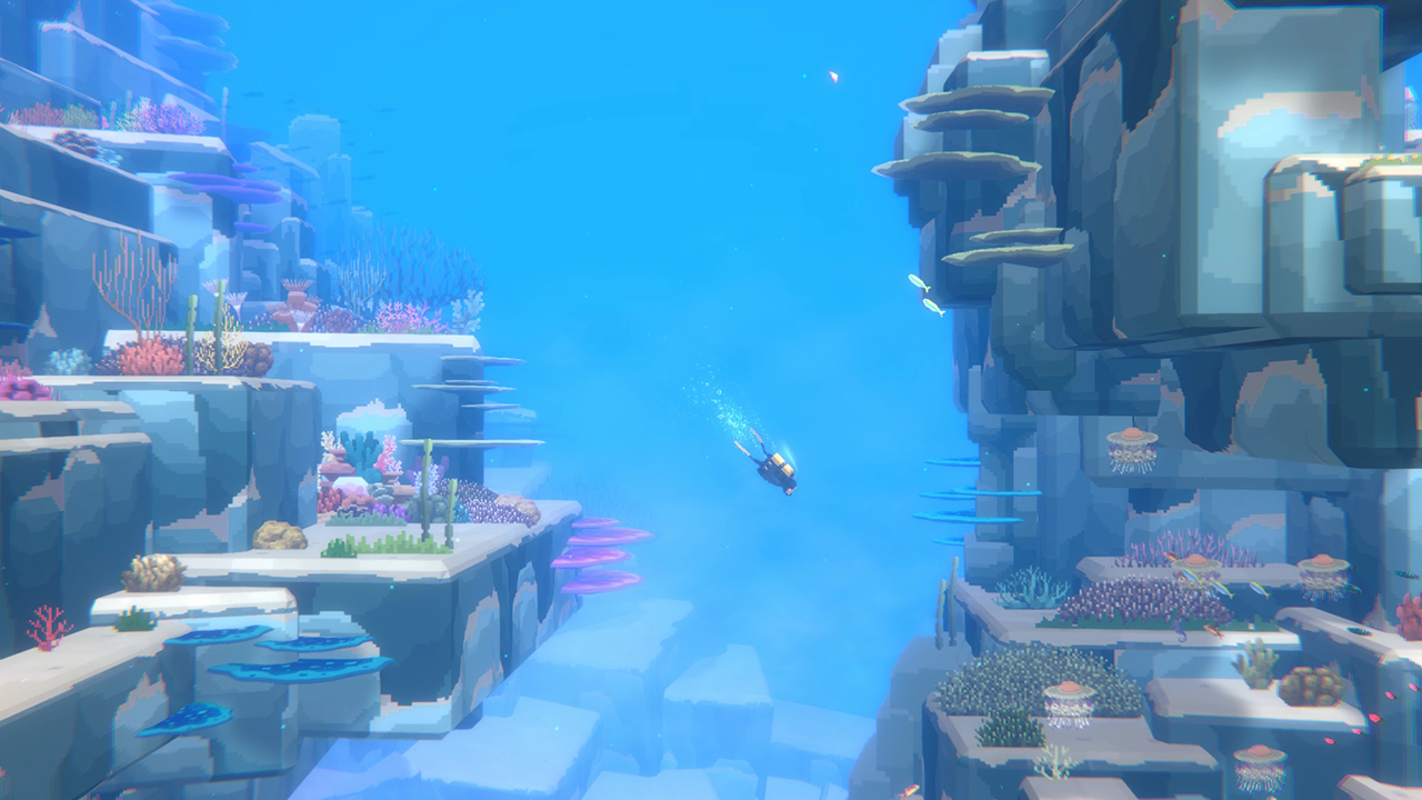 Dave the Diver Screenshot where you are diving into the ocean with rock formations on both sides of you.